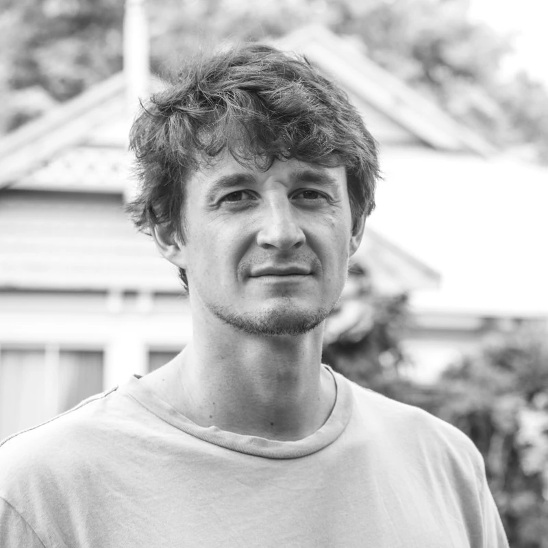 A render of three white cylindrical columns, against a warm creme background
